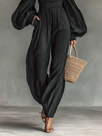 Dames jumpsuit van geplooid stof met blote schouders en lange mouwen